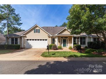 Charming ranch-style home with a two-car garage, lush lawn, mature landscaping, and inviting curb appeal at 4467 Antelope Ln, Charlotte, NC 28269