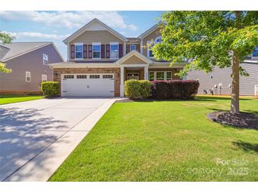 Charming two-story home features a well-manicured lawn, brick accents, and a two-car garage at 4935 Norman Park Pl, Clover, SC 29710