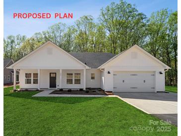 Charming one-story home featuring a two-car garage, well-manicured lawn, and classic architectural details at 834 Westminster Dr, Statesville, NC 28677