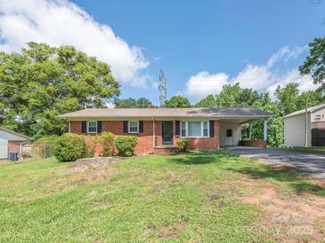 Charming single-story brick home with a well-maintained lawn and covered parking area at 876 Stowe Ln, Gastonia, NC 28056