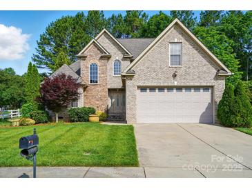 Charming brick home with lush green lawn, two-car garage, and mature trees offering curb appeal and Gathering comfort at 1705 Townsend Ln, Rock Hill, SC 29730