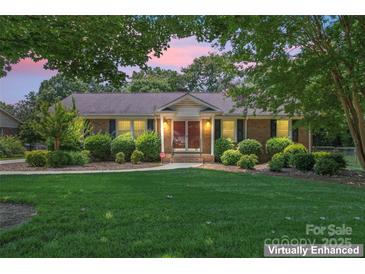 Charming brick home with manicured lawn and mature landscaping at 2715 Kennetuck Ct, Charlotte, NC 28273