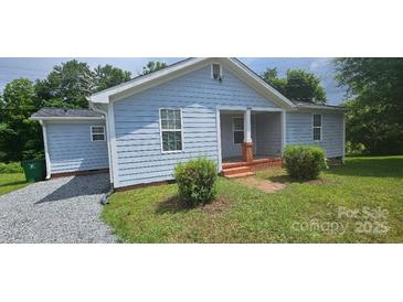 Charming single-story home with light blue siding, well-maintained landscaping, and a welcoming front porch at 2820 Bellhaven Cir, Charlotte, NC 28214
