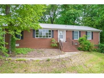 Charming brick home with classic shutters and a welcoming front entrance and a metal roof at 466 Shiloh Church Rd, Hickory, NC 28601