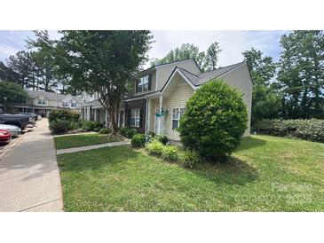 Charming townhome features a well-manicured lawn and traditional siding at 7504 Petrea Ln, Charlotte, NC 28227