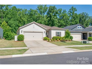 Charming single-Gathering home boasts a well-manicured lawn, two-car garage, and beautiful landscaping at 7530 Porrera St, Charlotte, NC 28214