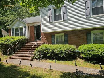 Charming two-story home with brick and siding, featuring a well-maintained front yard and inviting entryway at 7608 Surreywood Pl, Charlotte, NC 28270