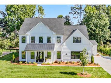 Beautiful new construction home with a modern farmhouse design and a large front yard at 1149 Rosecliff Dr, Waxhaw, NC 28173