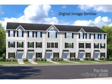 Inviting townhouse exterior with white siding, black shutters, and well-maintained landscaping at 3233 Dannelly Towns Aly # 1002C, Charlotte, NC 28208