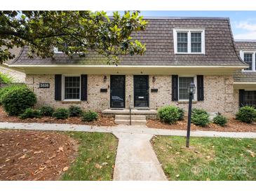 Charming brick townhome featuring a well-manicured lawn and classic architectural details at 3528 Colony Rd # A, Charlotte, NC 28211
