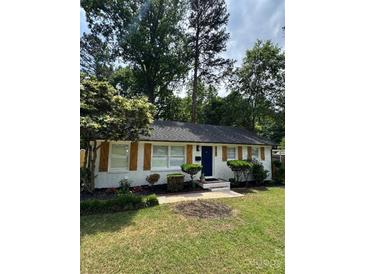 Charming single-story home with a manicured lawn and a classic brick facade at 3700 Denson Pl, Charlotte, NC 28215