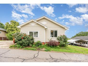 Charming home with a well-maintained lawn and inviting curb appeal under a partly cloudy sky at 380 Woodlawn Ave, Cramerton, NC 28032