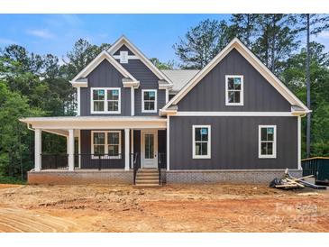 New construction featuring a covered front porch, board and batten siding, and professionally designed trim at 4315 Palm Dr, Denver, NC 28037