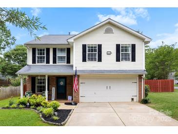 Charming two-story home with a well-manicured lawn, attached garage, and a welcoming front porch at 641 Saratoga Dr, Clover, SC 29710