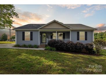 Charming single-story home featuring a welcoming front porch and well-maintained landscaping at 835 Jet St, Kannapolis, NC 28081