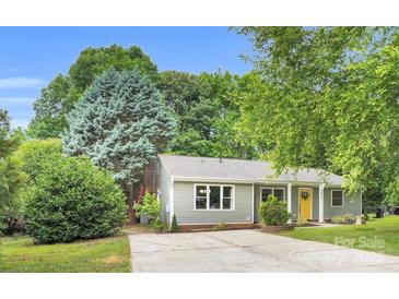 Charming single-story home with a well-manicured lawn, driveway, and light-colored siding at 9826 Meringue Pl, Charlotte, NC 28270