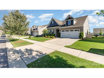 Charming home with manicured lawn, long driveway, and attached two-car garage at 13338 Blanton Dr, Huntersville, NC 28078