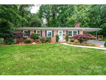 Charming brick ranch home with lush lawn, colorful landscaping, and covered parking at 1571 10Th Street Nw Pl, Hickory, NC 28601