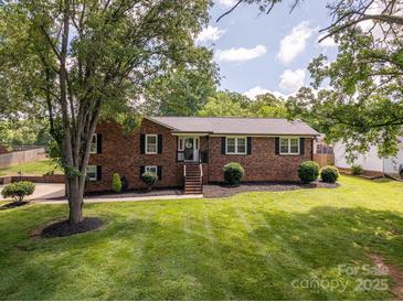 Charming brick home featuring a manicured lawn and mature trees at 1761 Arden Dr, Lincolnton, NC 28092