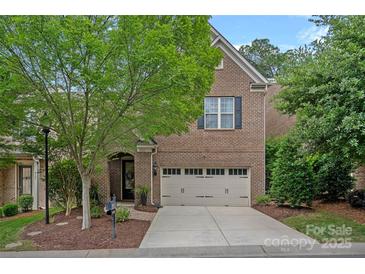 Charming brick home features a two-car garage and well-manicured landscaping, creating great curb appeal at 4311 Sheffield Park Ave, Charlotte, NC 28211