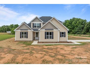 Charming two-story home features a symmetrical facade, complemented by black shutters and a well-manicured lawn at 4949 Rimer Rd # 4, Concord, NC 28025