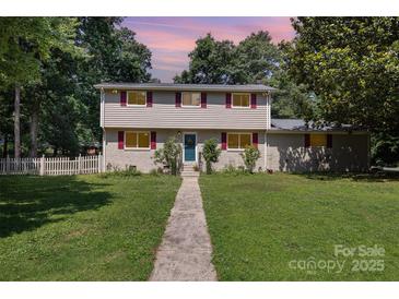 Charming two-story home with a well-manicured lawn and inviting walkway leading to the front door at 7015 Lavern St, Charlotte, NC 28215