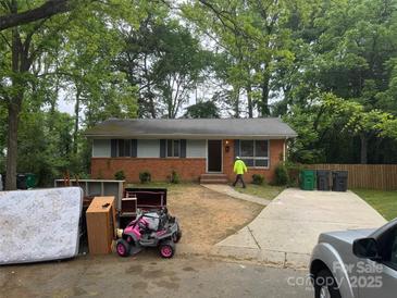 Charming single-story brick home with well-maintained lawn and mature trees in a serene neighborhood at 801 Davenport St, Charlotte, NC 28208