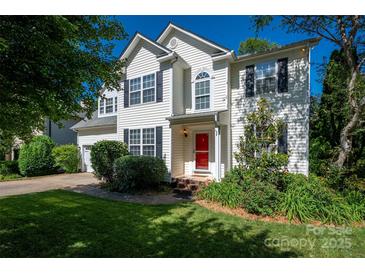Charming two-story home with a manicured lawn and bright red front door at 8619 New Oak Ln, Huntersville, NC 28078