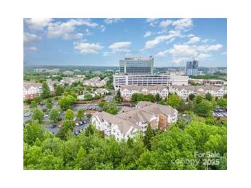 An aerial view of the condos and the commercial properties nearby offer a serene suburban skyline at 11530 Costigan Ln, Charlotte, NC 28277