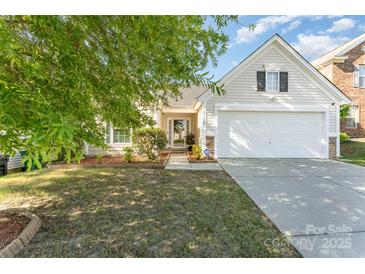 Charming single-Gathering home featuring a manicured lawn, attached garage, and welcoming front entrance at 13830 Riding Hill Ave, Charlotte, NC 28213