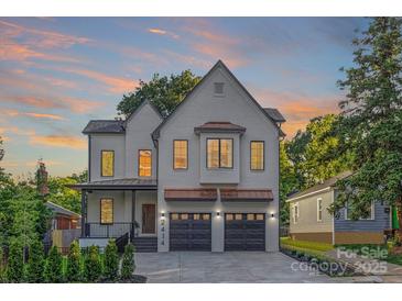 Beautiful two-story home with painted brick, copper accents, a covered porch, and a two-car garage at 2414 E 7Th St, Charlotte, NC 28204