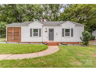 Charming single-story home featuring a well-manicured lawn, white siding, and gray shutters at 2601 Ashley Rd, Charlotte, NC 28208