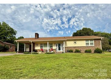 Charming single-story home with a covered front porch and well-maintained lawn at 403 Kings Dr, Cherryville, NC 28021