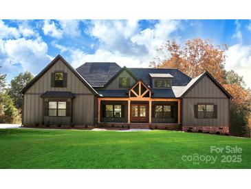 Charming home featuring an inviting front porch, neutral siding, and well-manicured lawn at 5016 Carolina North Dr, Gastonia, NC 28056