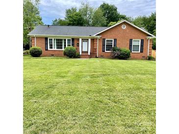 Charming brick home with a lush green lawn and well-maintained landscaping at 5734 Brookhaven Rd, Charlotte, NC 28210