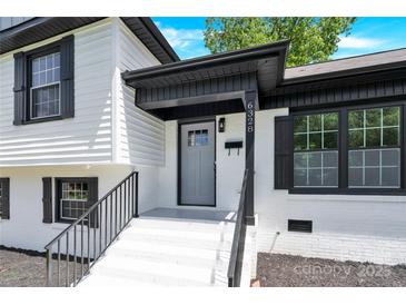 Inviting front entrance featuring a painted door, covered entry, and freshly painted steps at 6328 Beecher Dr, Charlotte, NC 28215