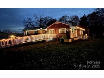 Charming single-story home with a brick exterior and a welcoming ramp decorated with string lights at 800 Charles Rd, Shelby, NC 28150