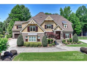 Charming home features a brick and siding exterior, manicured landscaping, and a welcoming front entrance at 9104 Kingsmead Ln, Waxhaw, NC 28173