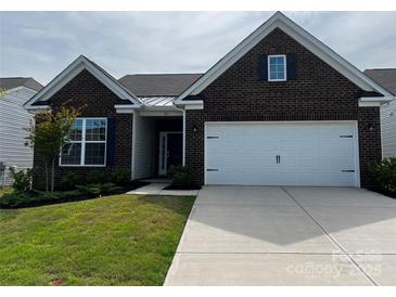 Charming brick home with a two-car garage and well-maintained lawn and front yard at 147 Dubois Dr, Mooresville, NC 28115