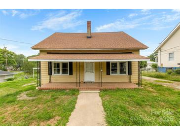 Charming one-story house with a covered front porch and well-maintained lawn at 217 S Highland St, Gastonia, NC 28052
