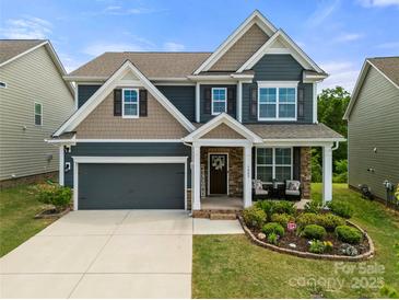 Beautiful two-story home with a manicured lawn, covered porch, and a two-car garage at 3009 Lydney Cir, Waxhaw, NC 28173