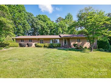 Charming brick home with a well-manicured lawn and mature landscaping at 308 Odell St, Kannapolis, NC 28083