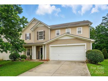 Charming two-story home with a two-car garage and well-maintained lawn at 512 Nanny Point Dr, Monroe, NC 28110
