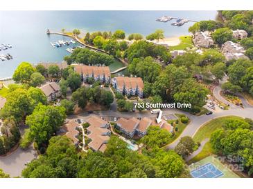 Stunning aerial view of 753 Southwest Drive in a lakeside community with a pool, tennis court, and marina at 753 Southwest Dr, Davidson, NC 28036