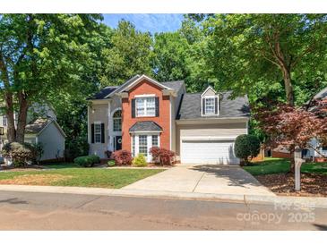 Charming two-story home with brick and siding exterior and attached two car garage at 10419 Chelsea Bay Dr, Charlotte, NC 28278