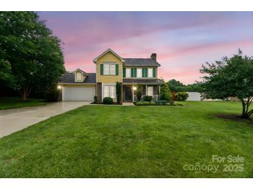 Charming two-story home with a well-manicured lawn and colorful sunset backdrop, creating a welcoming curb appeal at 105 Carmel Hills Dr, Gastonia, NC 28056