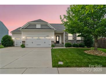 Charming home featuring a well-manicured lawn, stone accents, and a two-car garage, perfect for modern living at 2112 Balting Glass Dr, Indian Trail, NC 28079