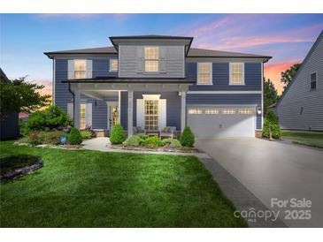 Charming two-story home with a well-manicured lawn, covered porch, and attached two-car garage at 5050 Havencrest Dr, Fort Mill, SC 29715