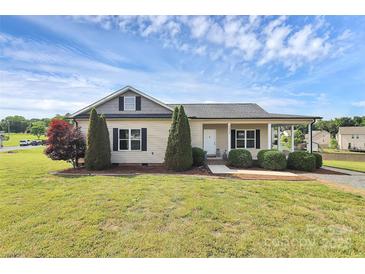 Charming single-story home featuring a cozy front porch and well-manicured landscaping at 5333 Lake Glenn Dr, Stanfield, NC 28163