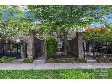 Charming brick townhome with a well-manicured lawn and mature trees in a desirable location at 6011 Nw Village Nw Dr, Concord, NC 28027